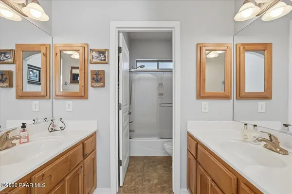 a bathroom with a double vanity sink mirror and