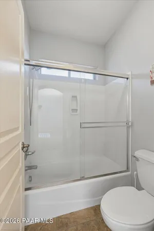 a bathroom with a shower and a toilet