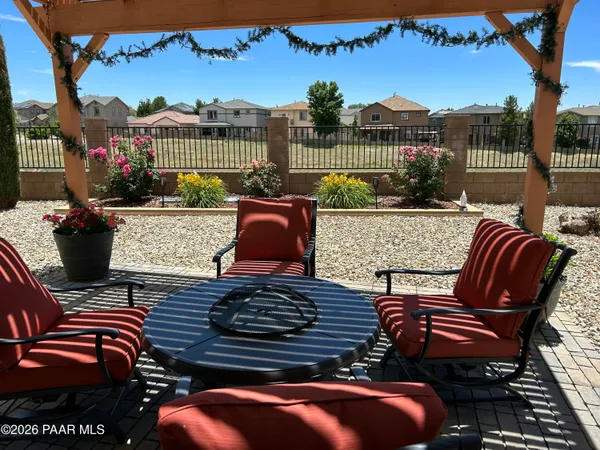 a view of a patio with couches table and chairs and potted plants