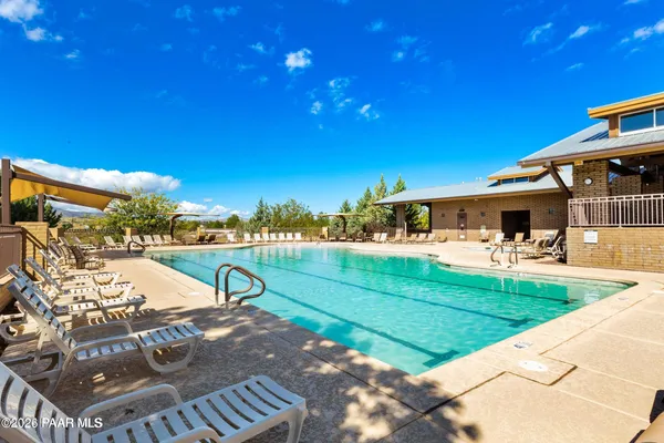 a swimming pool with outdoor seating and yard