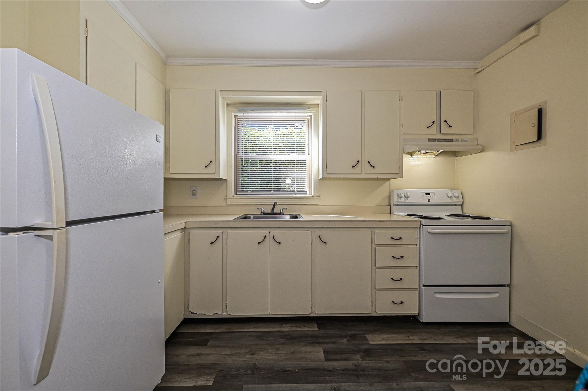 260 Church Street North, Unit 2 Concord, NC 28025 - Photo 2 of 12 a kitchen with granite countertop a refrigerator sink and cabinets