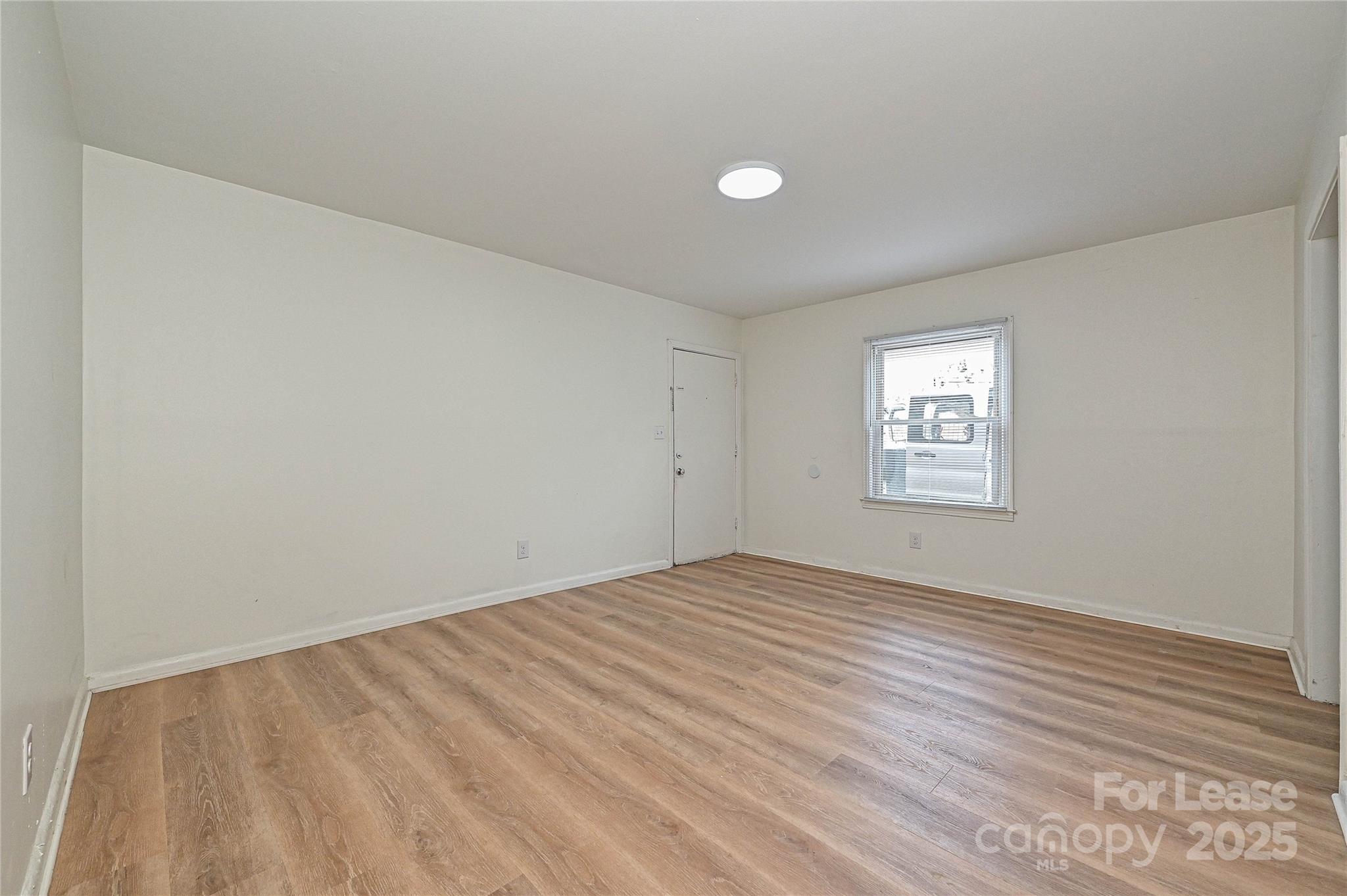 260 Church Street North, Unit 2 Concord, NC 28025 - Photo 6 of 12 a view of empty room with wooden floor and fan