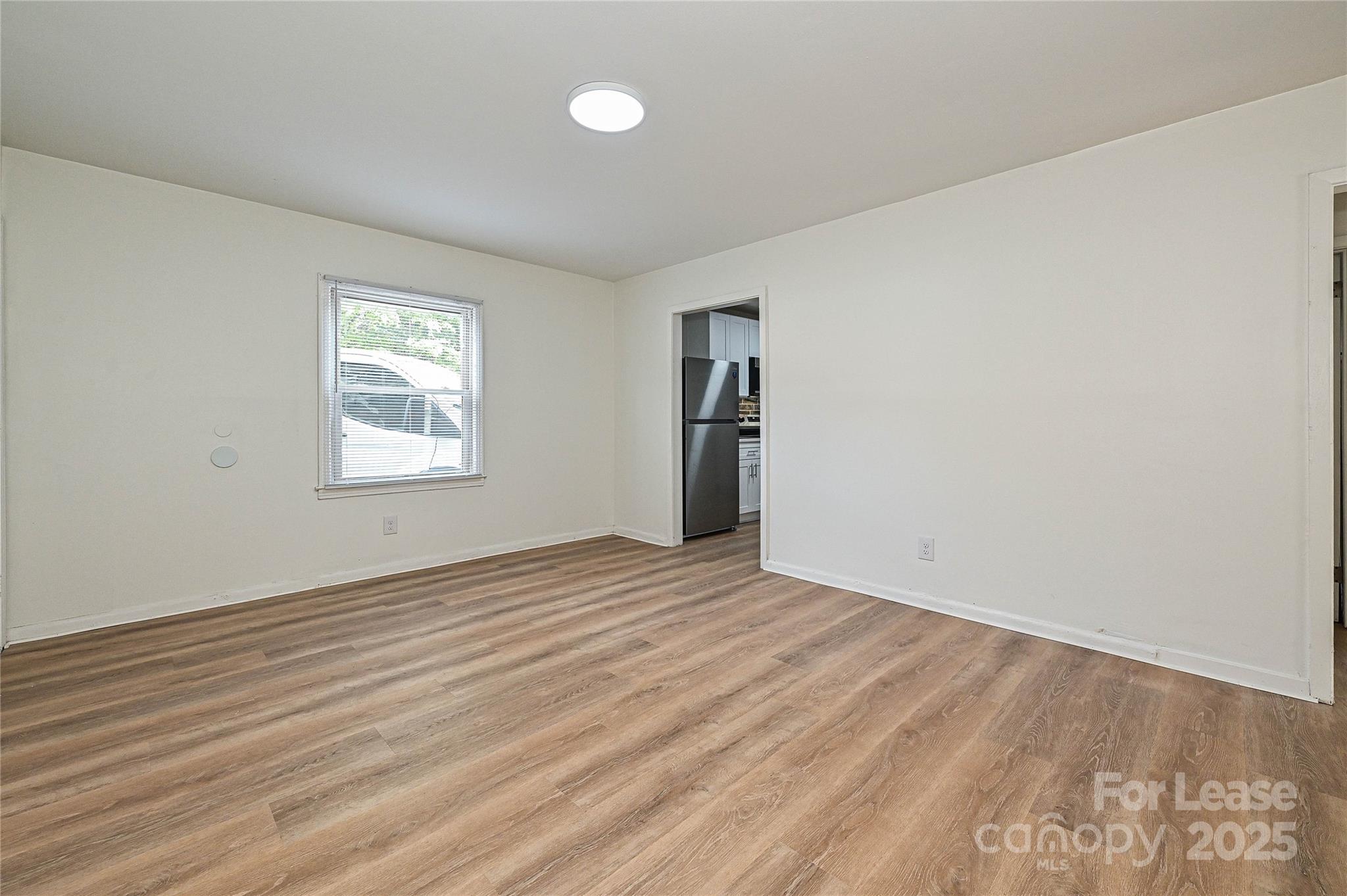 260 Church Street North, Unit 2 Concord, NC 28025 - Photo 7 of 12 wooden floor in an empty room with a window