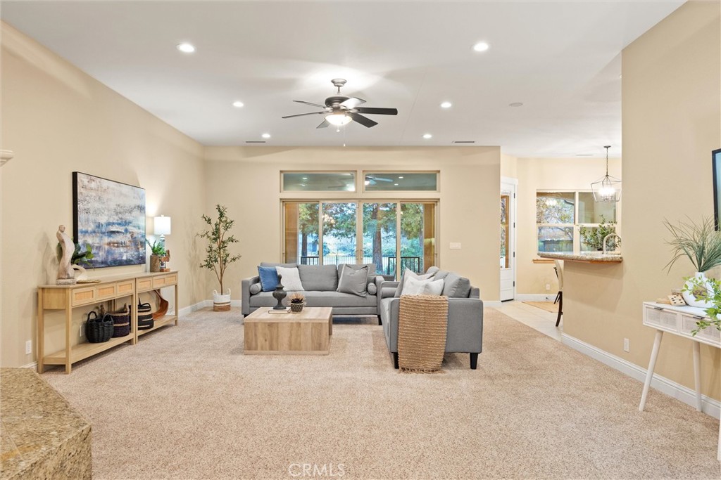 10473 Bogie Way Chico, CA 95928 - Photo 19 of 46 a living room with furniture a fireplace and a chandelier