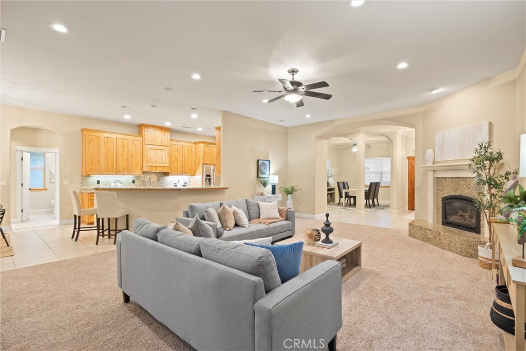 10473 Bogie Way Chico, CA 95928 - Photo 21 of 46 a living room with furniture a fireplace and a kitchen view