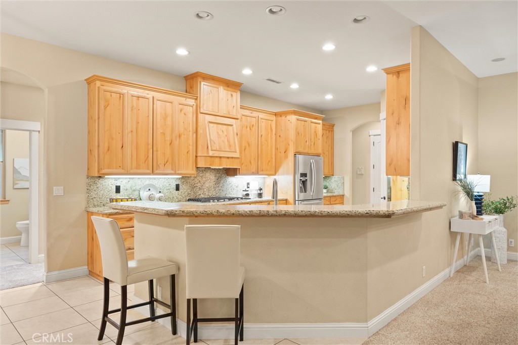 10473 Bogie Way Chico, CA 95928 - Photo 22 of 46 a kitchen with stainless steel appliances granite countertop a sink and a refrigerator