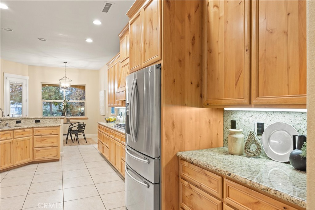 10473 Bogie Way Chico, CA 95928 - Photo 26 of 46 a kitchen with stainless steel appliances granite countertop a refrigerator and a sink