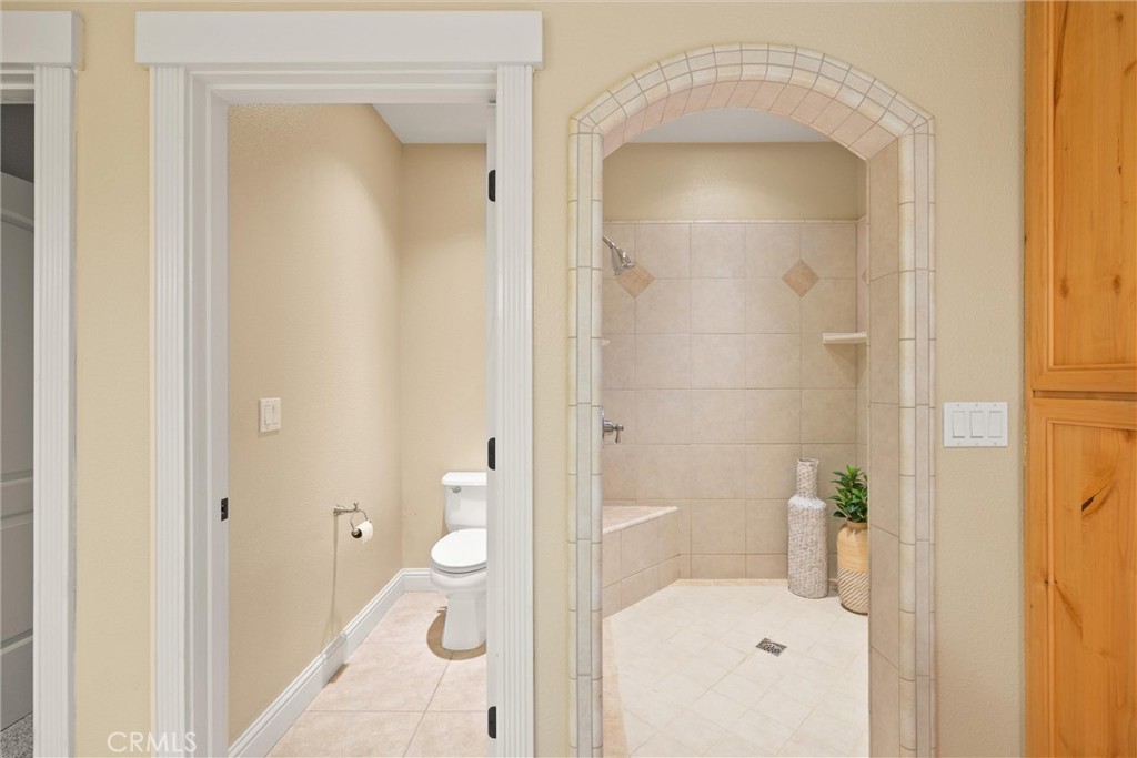 10473 Bogie Way Chico, CA 95928 - Photo 35 of 46 a bathroom with a granite countertop sink a mirror and a shower