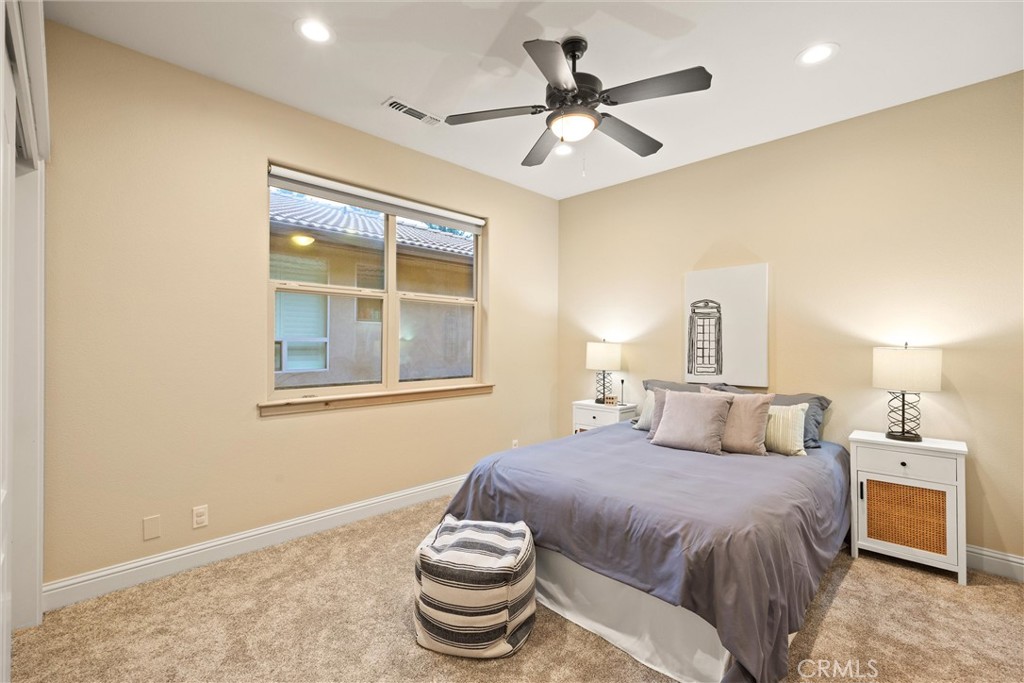 10473 Bogie Way Chico, CA 95928 - Photo 38 of 46 a bedroom with a bed and a chandelier