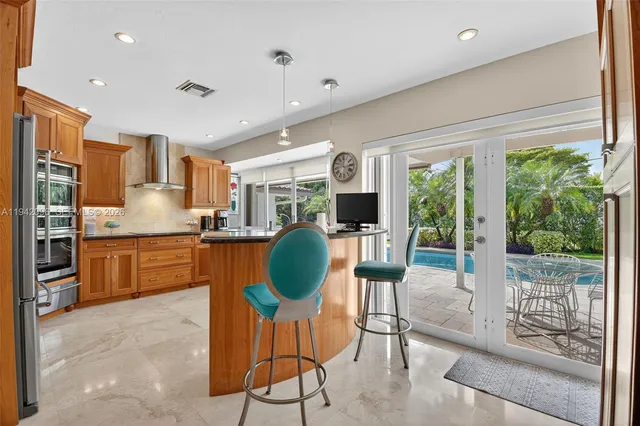 a kitchen with stainless steel appliances granite countertop a stove and a sink