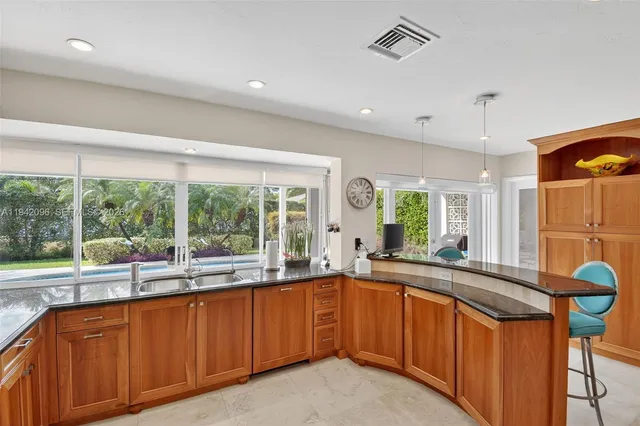 a kitchen with stainless steel appliances granite countertop a refrigerator and a stove top oven