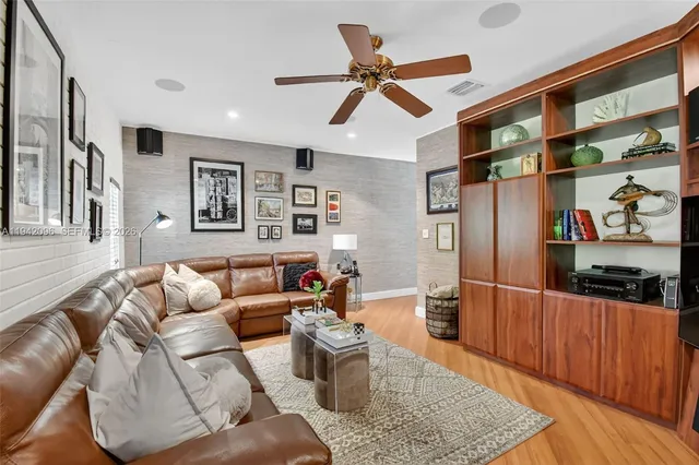 a bedroom with a bed and a ceiling fan