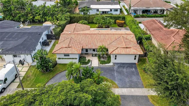 an aerial view of a house with garden space and street view