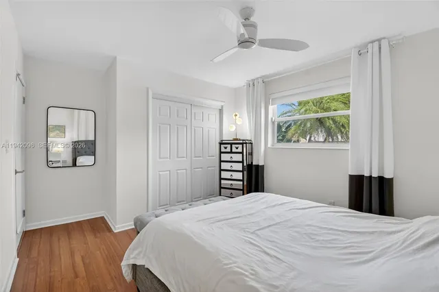 a view of a patio with table and chairs potted plants with wooden floor and fence