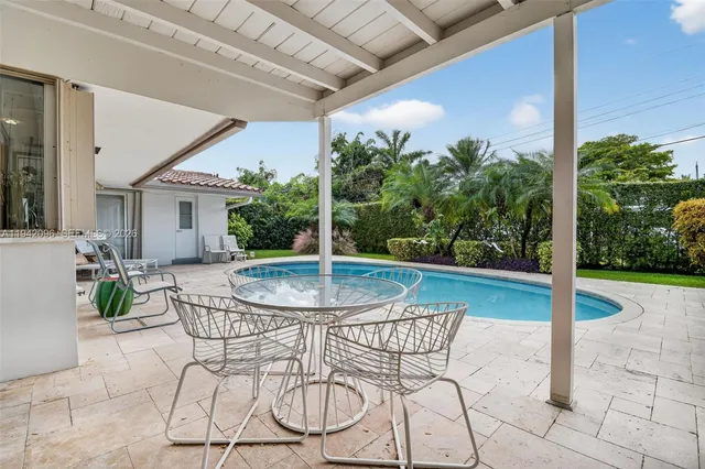 a view of a swimming pool with sitting area