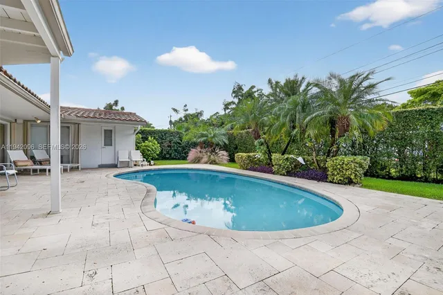 an aerial view of a houses with a yard