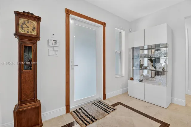 a walk in closet with wooden floor