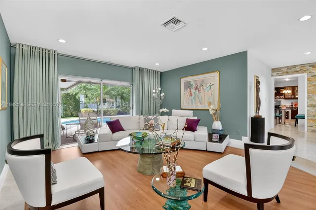 a living room with furniture and a large window