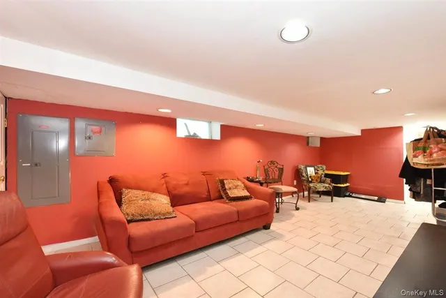 a living room with furniture a lamp and a large window