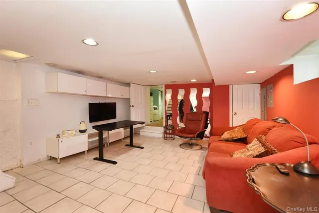 a living room with furniture gym equipment and a flat screen tv