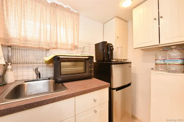 a kitchen with a refrigerator and a sink