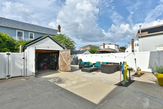 a view of a patio with table and chairs a barbeque