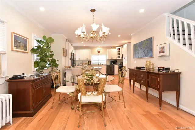 a living room with dining room and wooden floor