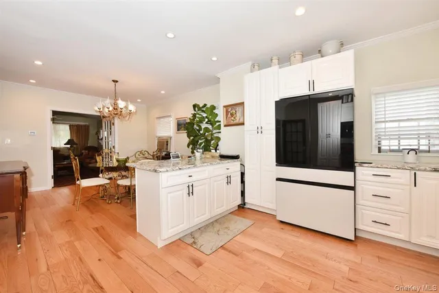 a kitchen with stainless steel appliances kitchen island granite countertop a refrigerator and a stove top oven