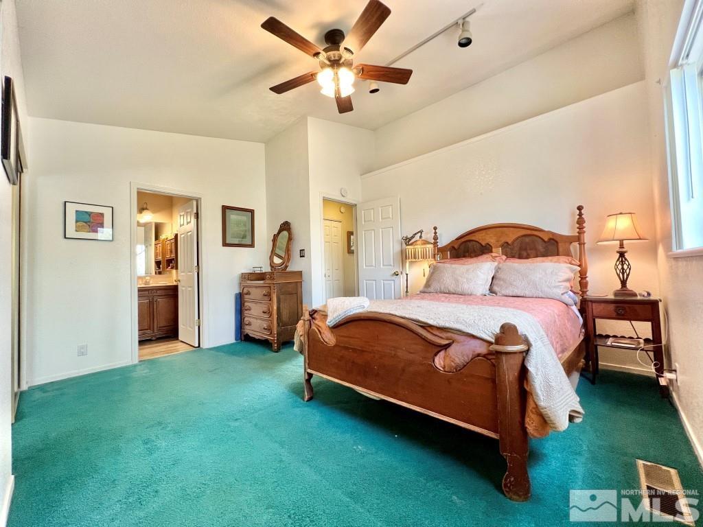 3365 Lookout Place Reno, NV 89503 - Photo 18 of 39 a bedroom with a bed and a chandelier