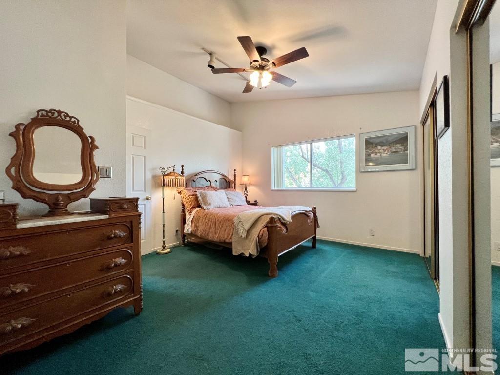 3365 Lookout Place Reno, NV 89503 - Photo 20 of 39 a bedroom with a bed and a chandelier