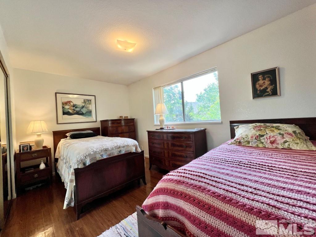 3365 Lookout Place Reno, NV 89503 - Photo 26 of 39 a bedroom with a large bed and a chandelier