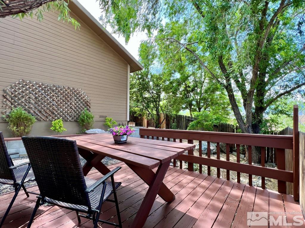 3365 Lookout Place Reno, NV 89503 - Photo 36 of 39 a view of a patio with table and chairs with wooden floor and fence