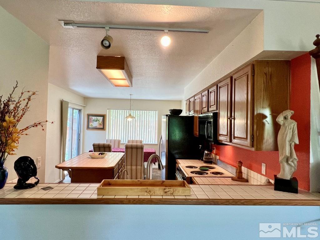 3365 Lookout Place Reno, NV 89503 - Photo 6 of 39 a living room with furniture a flat screen tv and kitchen view