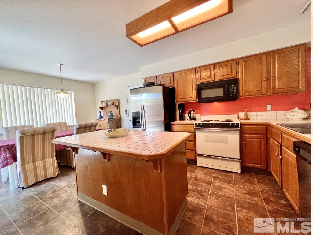 3365 Lookout Place Reno, NV 89503 - Photo 7 of 39 a kitchen with a stove a sink and a refrigerator