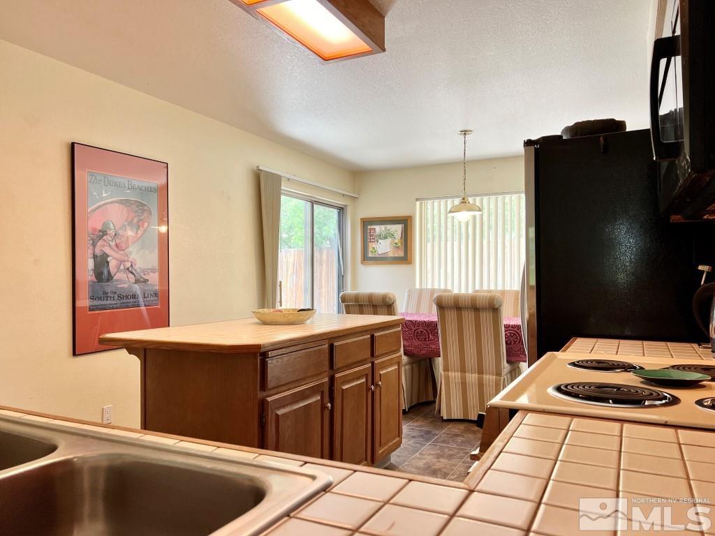 3365 Lookout Place Reno, NV 89503 - Photo 9 of 39 a kitchen with stainless steel appliances granite countertop a sink stove and refrigerator