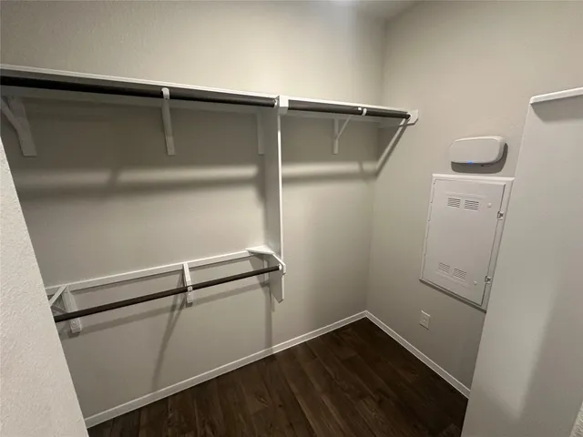 a view of walk in closet with empty racks