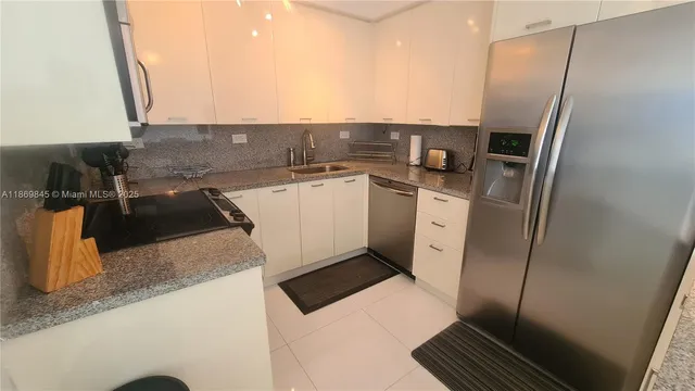 a kitchen with stainless steel appliances a refrigerator and a sink