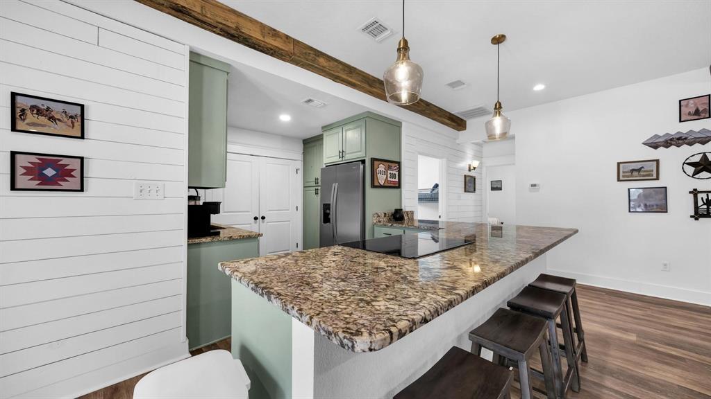 133 Prairie Lane Weatherford, TX 76087 - Photo 13 of 38 a kitchen with granite countertop kitchen island stainless steel appliances a sink stove and wooden floor