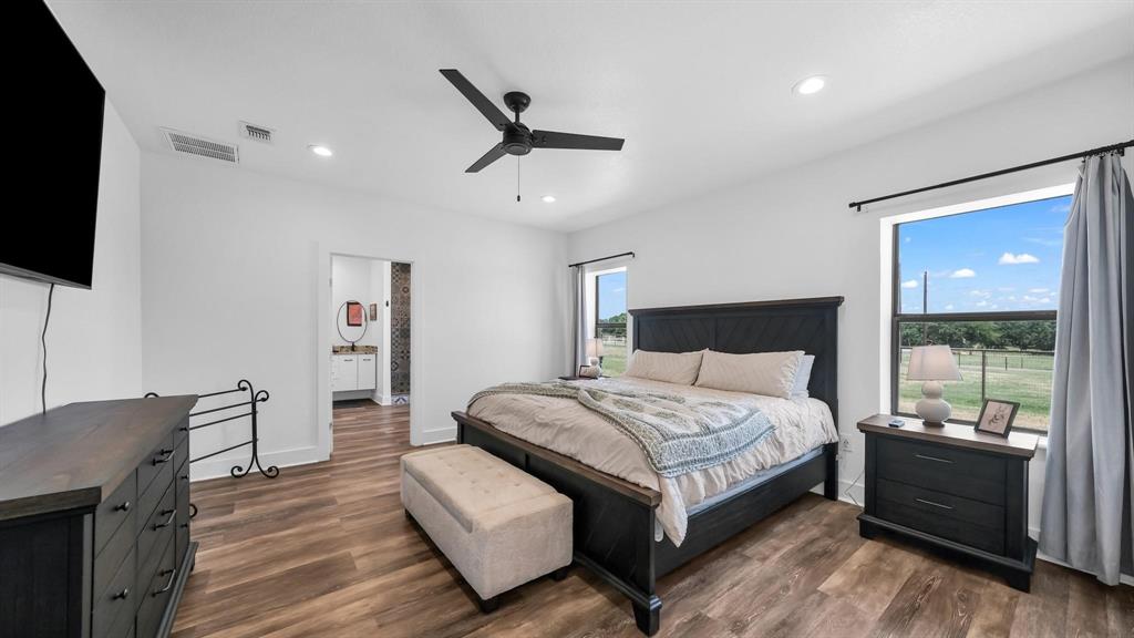 133 Prairie Lane Weatherford, TX 76087 - Photo 19 of 38 a bedroom with a bed and a television