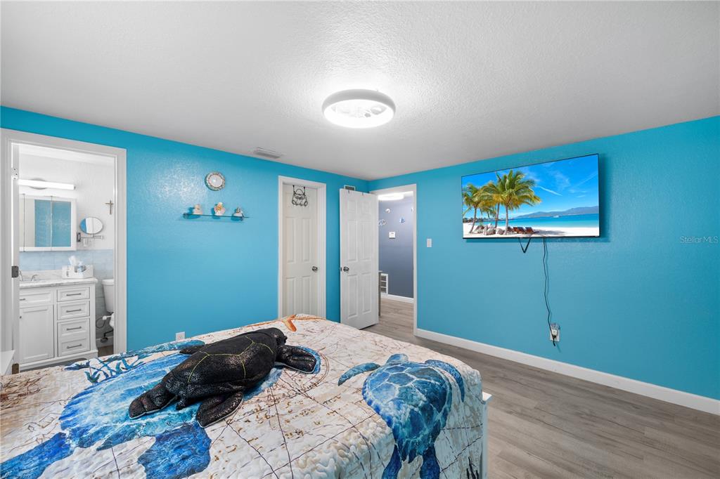 3336 Gulfview Drive Hernando Beach, FL 34607 - Photo 19 of 45 a bedroom with a bed and a painting on the wall