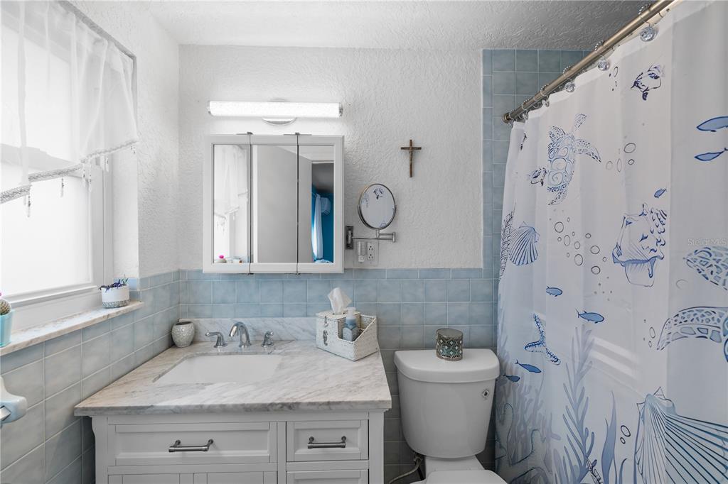 3336 Gulfview Drive Hernando Beach, FL 34607 - Photo 20 of 45 a bathroom with a granite countertop sink mirror vanity and toilet