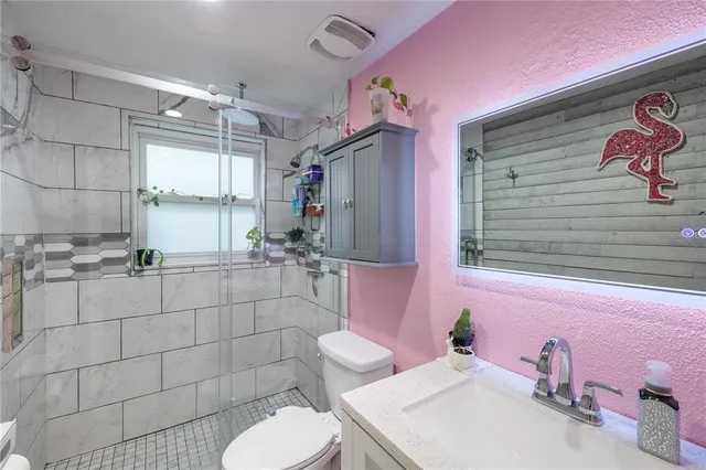 a bathroom with a sink toilet and shower