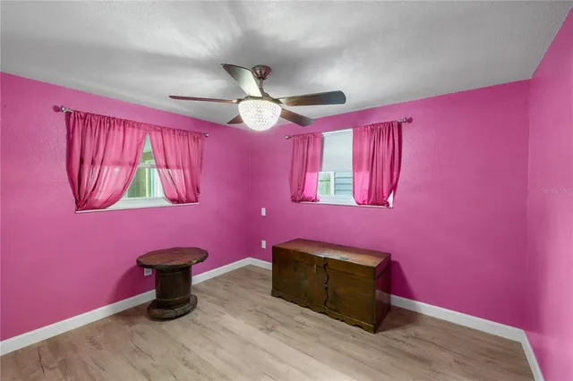 a view of a livingroom with furniture and chandelier fan