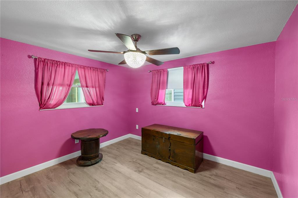 3336 Gulfview Drive Hernando Beach, FL 34607 - Photo 27 of 45 a room with wooden floor and furniture