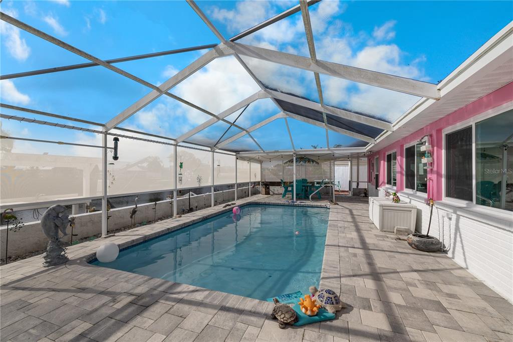 3336 Gulfview Drive Hernando Beach, FL 34607 - Photo 31 of 45 a view of a patio with a table and chairs under an umbrella
