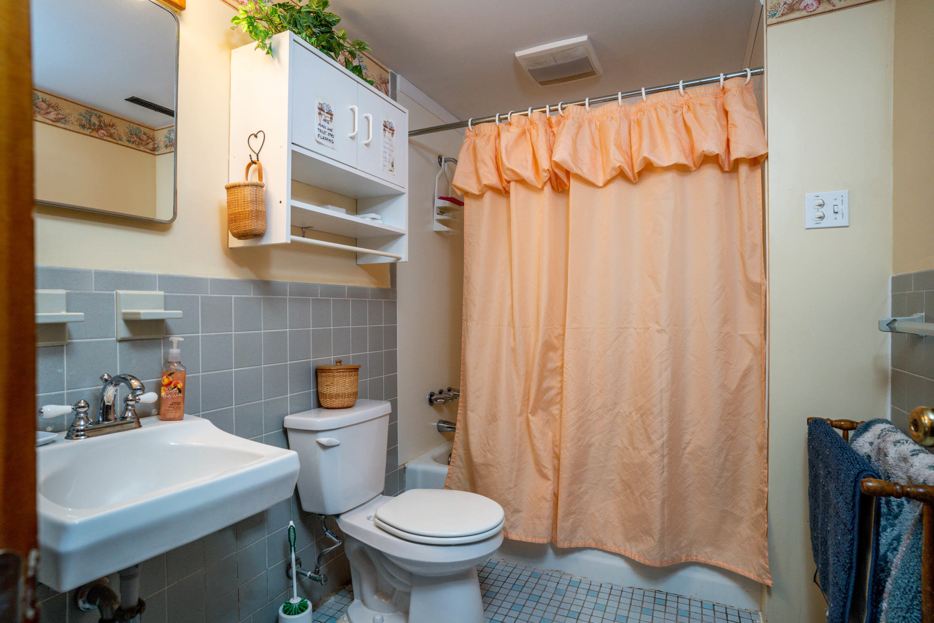 45 King Phillip Road Wellfleet, MA 02667 - Photo 19 of 22 a bathroom with a sink a toilet and shower curtain