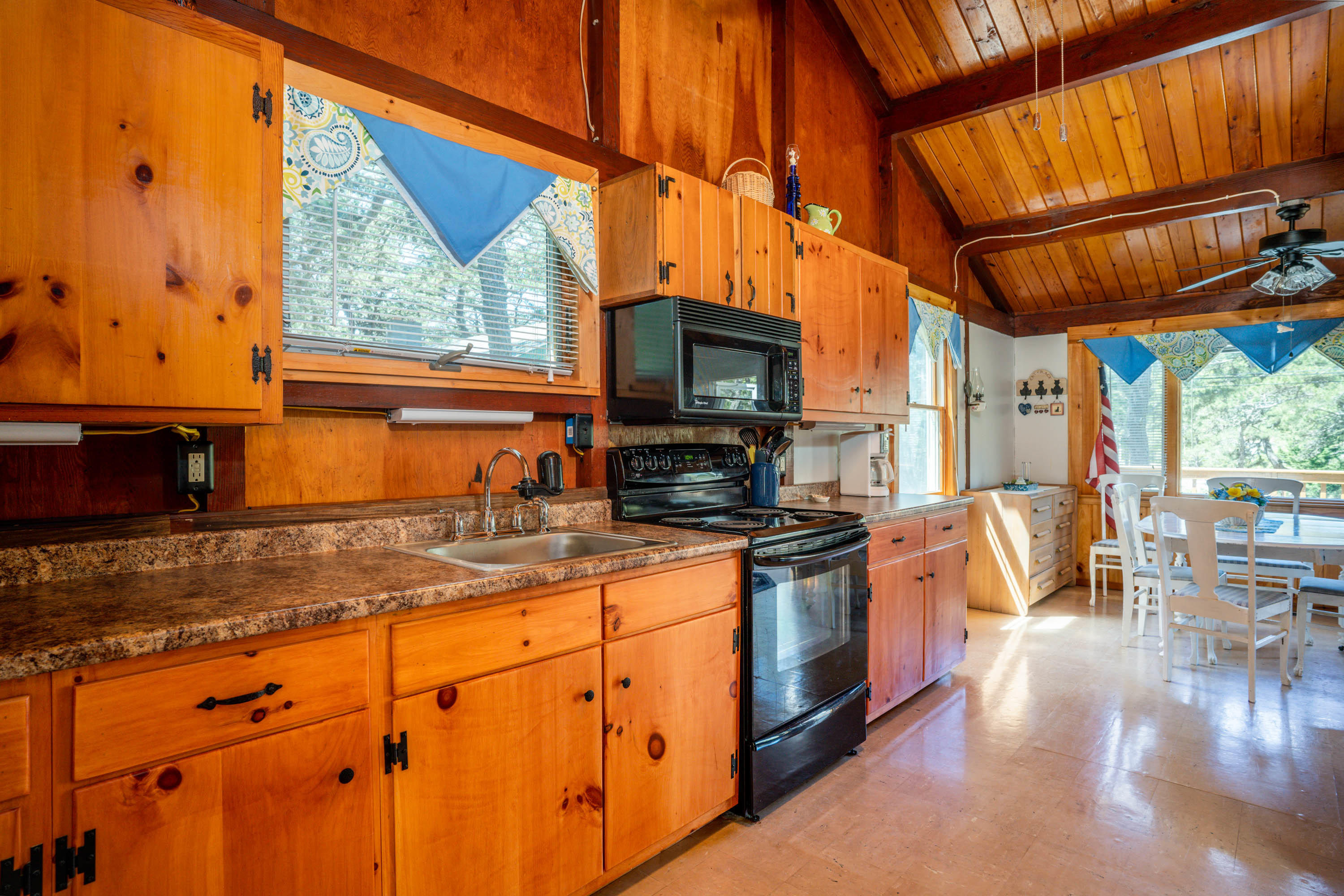 45 King Phillip Road Wellfleet, MA 02667 - Photo 8 of 22 a kitchen with stainless steel appliances granite countertop a stove a sink and a microwave