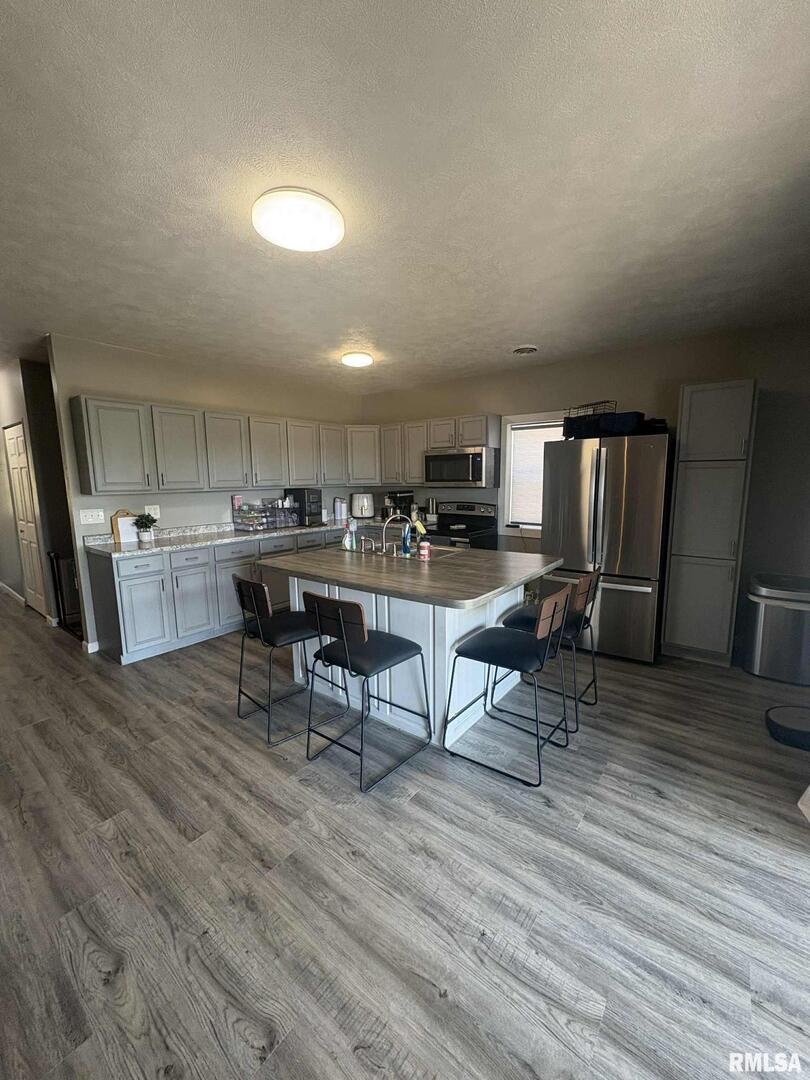 23115 Highway 14 Macedonia, IL 62860 - Photo 11 of 34 a living room with stainless steel appliances furniture and wooden floor