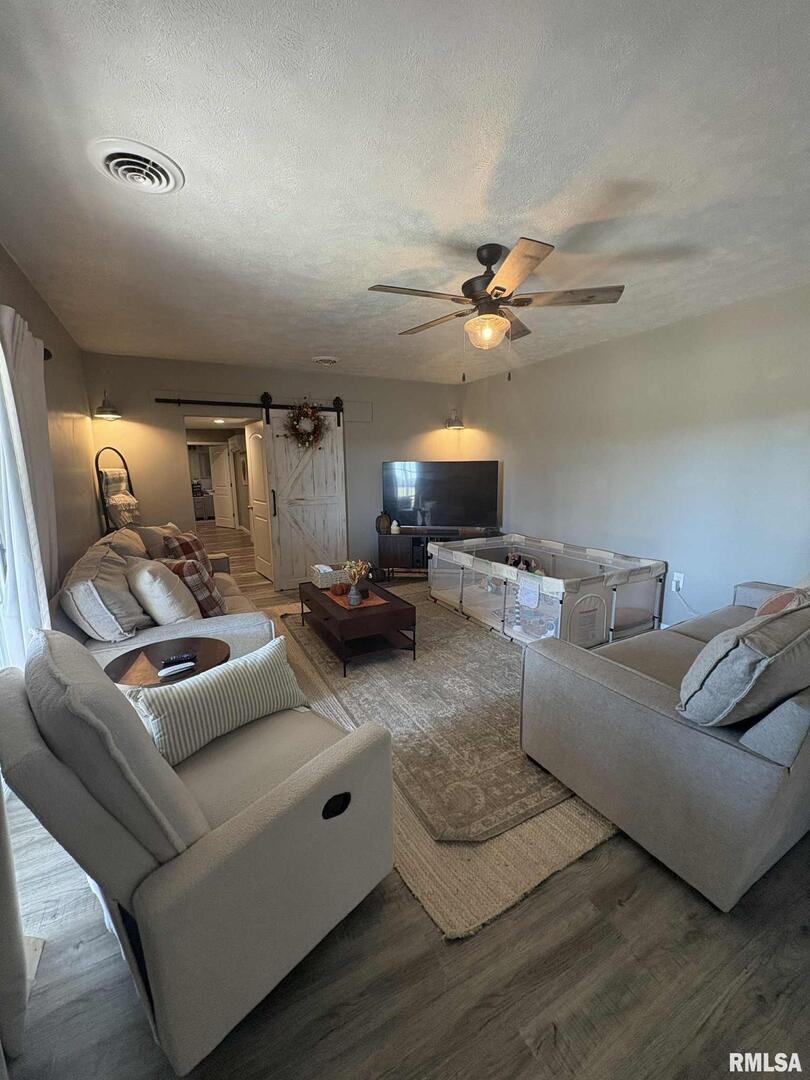 23115 Highway 14 Macedonia, IL 62860 - Photo 12 of 34 a living room with furniture and a chandelier