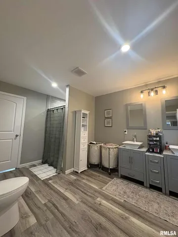 a spacious bathroom with a bathtub sink and mirror